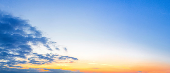 Cloudy sky with the orange sun