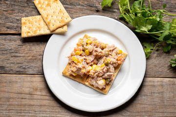 Tuna salad with mayonnaise on wooden background