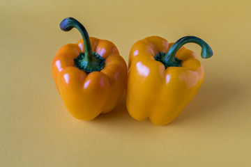 Yellow bell peppers on yellow paper