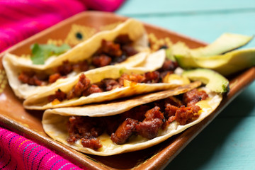 Mexican quesadillas with chorizo on turquoise background