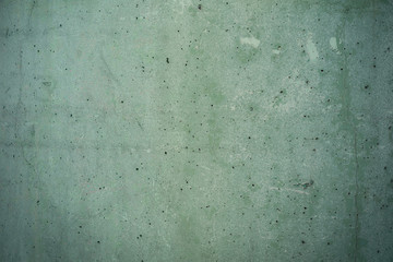 damaged green concrete  background texture with small holes and scratches