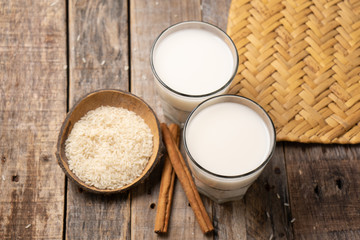 Mexican rice horchata with cinnamon on wooden background