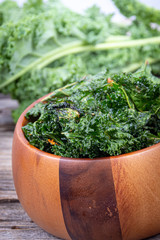 green kale chips snack on a wooden bowl