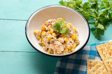 Tuna salad with mayonnaise on turquoise background