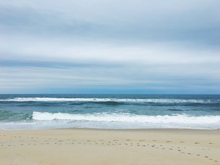 Fototapeta na wymiar Waves crashing on an empty beach