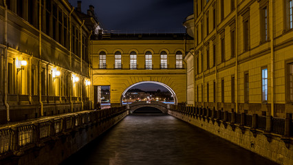 Fototapeta na wymiar Night view of the Hermitage Arch through the Winter Canal.