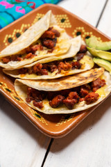 Mexican quesadillas with chorizo on white background