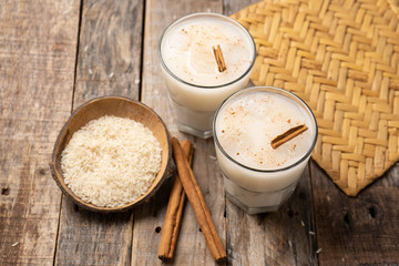 Mexican rice horchata with cinnamon on wooden background