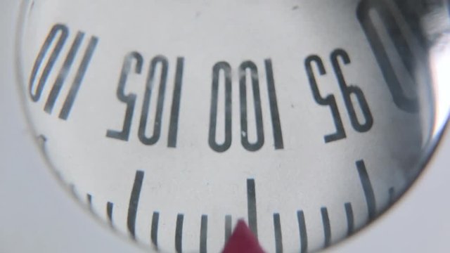 Mechanical weighing scales. An old weighing scale dial close up