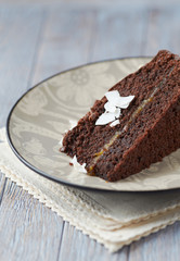 Piece of chocolate cake on wooden background.
