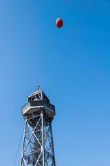 Steel tower of the cableway air transport system in Barcelona Spain with Red Cabin seen from below