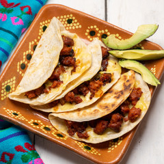 Mexican quesadillas with chorizo on white background