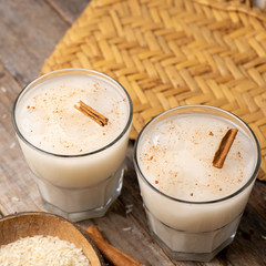 Mexican rice horchata with cinnamon on wooden background
