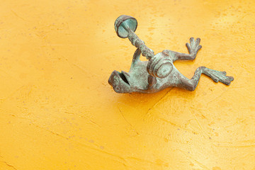 green  frog doing exercise in yellow background 