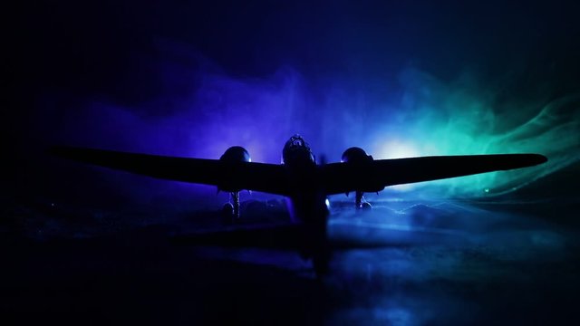 German Junker (Ju-88) night bomber at night. Artwork decoration with scale model of jet-propelled plane in possession. Toned foggy background with light. War scene. Selective focus