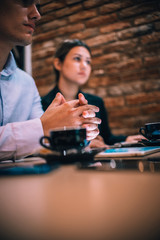 Happy millennial couple listens carefully to their financial consultant over a coffee meeting