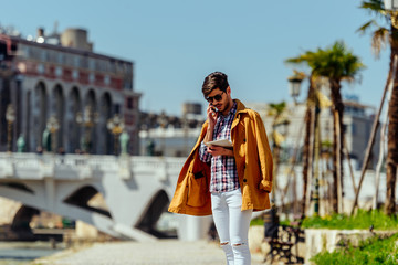 Fototapeta premium Cheerful businessman talking on mobile phone