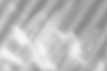 Blurred abstract background. Shadow from the window with sunbeams on the white wall. Black and white image to overlay a photo or Mockup