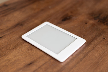 white digital book on the wooden table