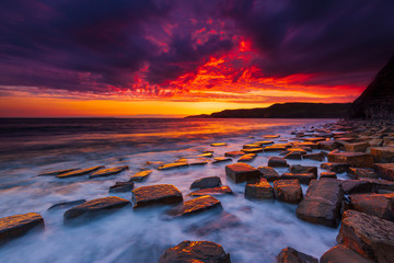The sky clears after a rain storm just long enough to show the deep red and purple clouds over the...