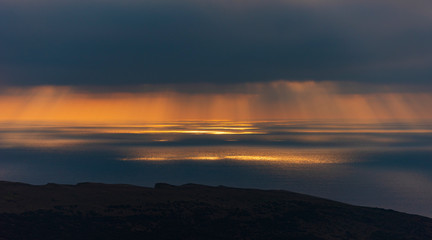 Fototapeta premium Crepuscular rays illuminating the sea off the Dorset coastline