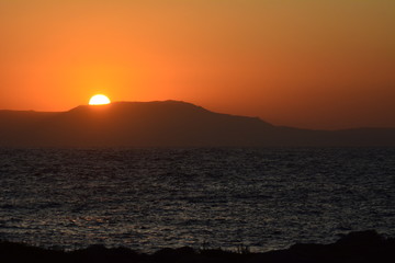Sun setting over mountain on a Greek Island