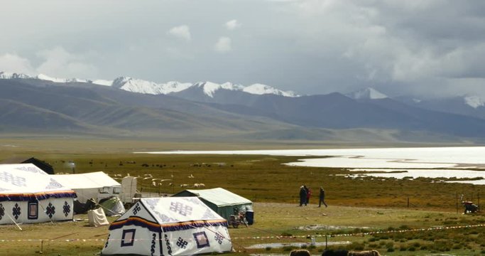 4k huge clouds mass rolling over lake namtso,tibet mansarovar,herdsman tent,a group of cow,Tibet's second largest lake,is the third largest saltwater lake in China.