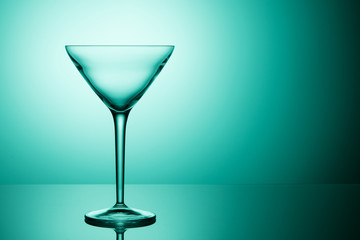 Empty martini glass. Beautiful turquoise gradient.