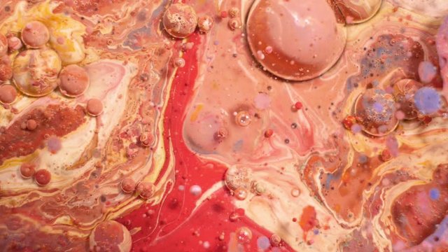 Colorful acrylic paints mix in beautiful patterns