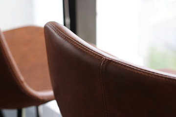 Close up detail of brown leather stools