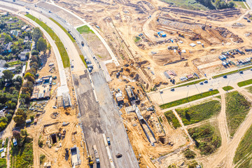 aerial top down view on city construction site. building of new asphalt road in residential district
