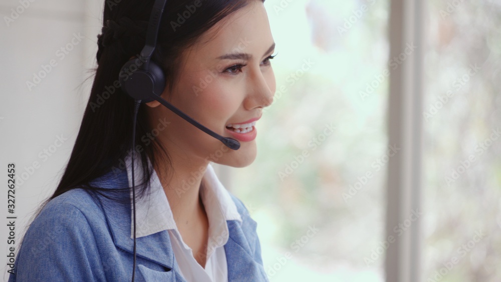 Aufkleber customer support agent or call center with headset works on desktop computer while supporting the cu