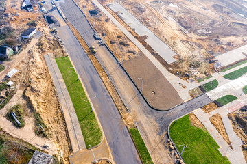 Obraz premium construction of road intersection at new residential district. top view aerial photo from flying drone