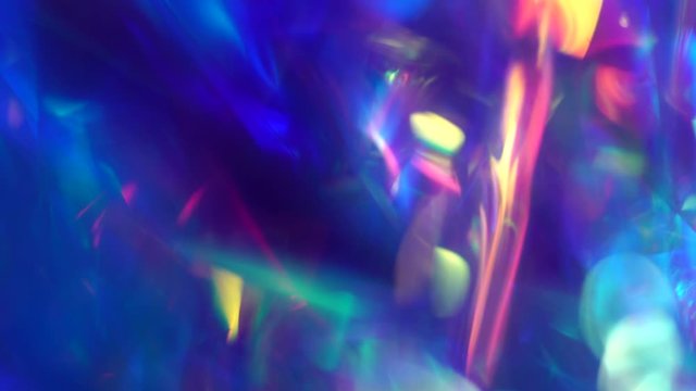 Pink, purple, blue, neon colors abstract vibrant iridescent background. Light through a crystal prism. Psychedelic movement