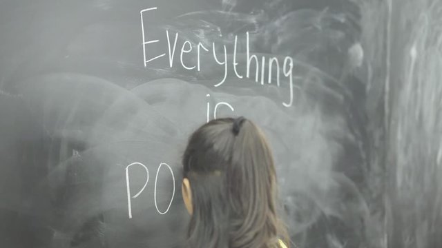 Female student writes text of Everything is Possible