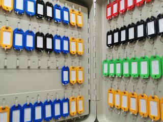 Colorful key rings hanging on the hook key metal safe box.