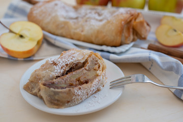Healthy Home made sweet Apple strudel with apples, cinnamon on a table