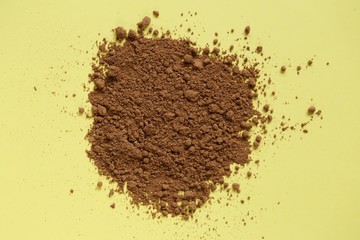 guarana powder  on a light yellow background.Super food. Healthy eating concept. Natural energetic. Portion of Guarana Powder.	 Pile of guarana powder.top view, copy space.