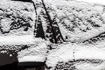 The car was completely covered with snow in the backyard.