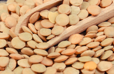 Heap of green lentil with wooden spoon. Healthy lifestyles and nutrition