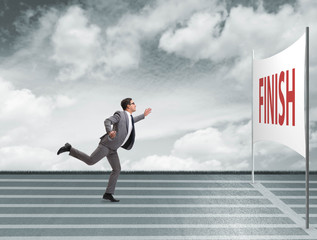 Businessman on the finishing line in competition concept