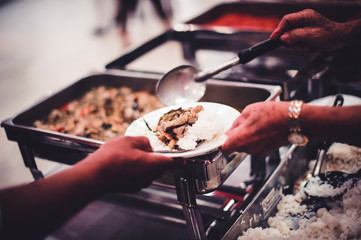 Sharing food with the poor in Thailand