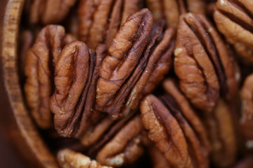 Pecan nut. Pecan  macro texture. Useful products. Vegan and veggie nutrition ingredient. Low carbohydrate nutrition. Brown raw nuts background.