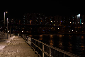 Empty promenade in the Maryino district at night with dim light.