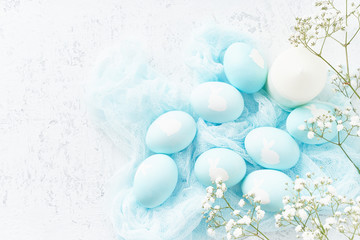 Easter. Holiday. Light white background, gentle pastel colors. Blue eggs with image of rabbit