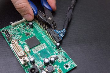 The process of repairing an electronic circuit board monitor.  The work of the master electronic...