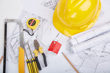 Yellow hard hat tools and drawings