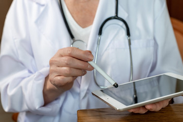 Ärztin zeigt auf ein Tablet