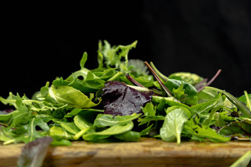 Close up of green salad mix. Fresh salad with rucola, purple lettuce, spinach, frisee and chard leaf