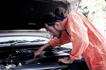 Fototapeta na wymiar A mechanic is fixing car system in automobile service center